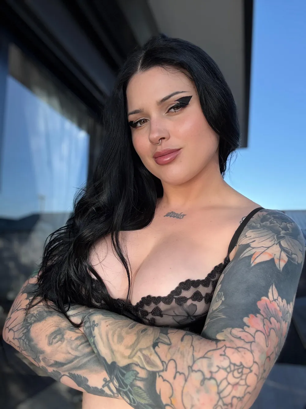 Demi, an Australian goth OnlyFans creator with black hair and full sleeve tattoos.