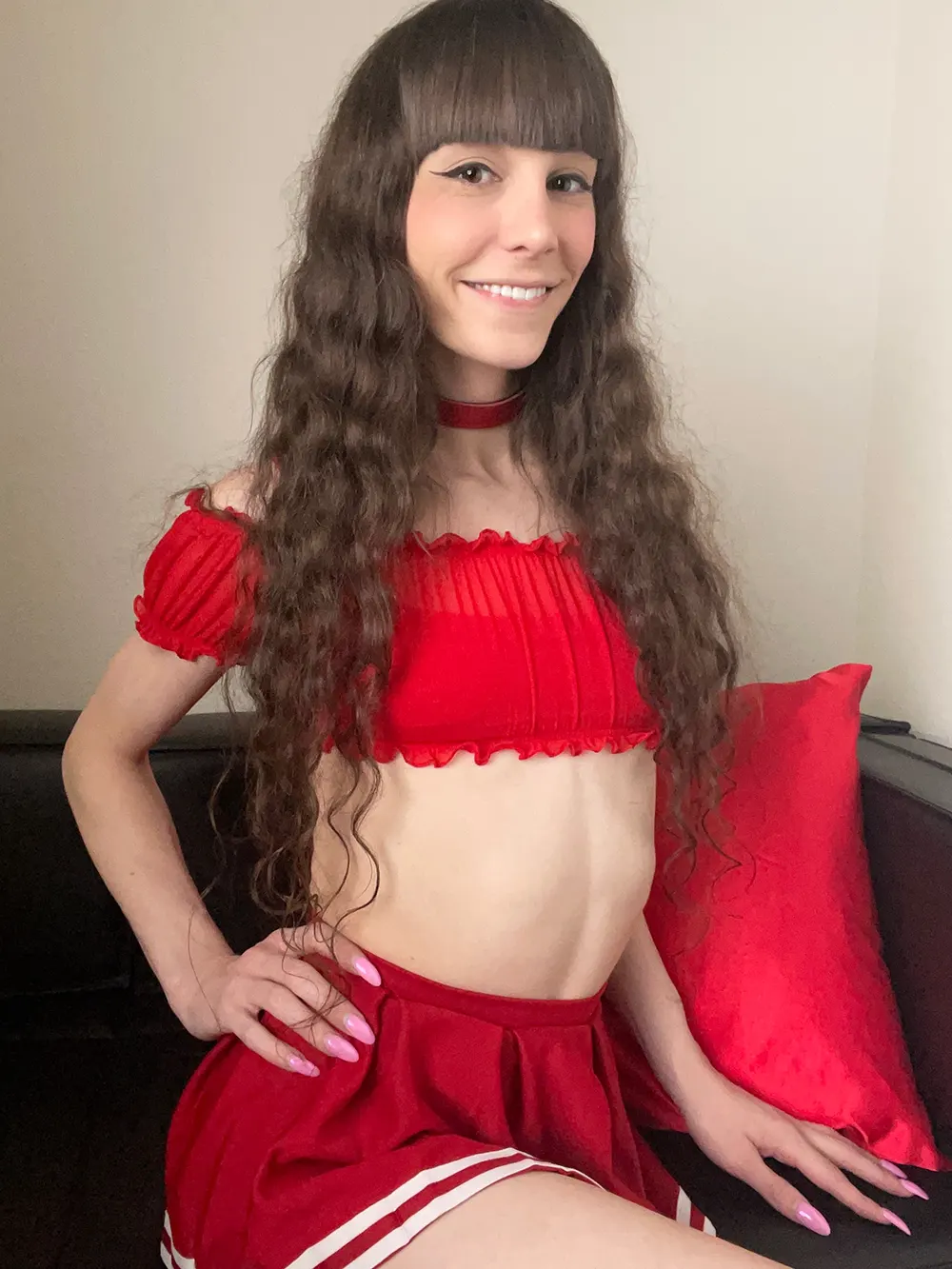 Sexy trans model wearing red top.